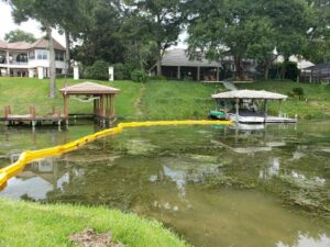 Homeowner lakefront weed removal with silt curtains